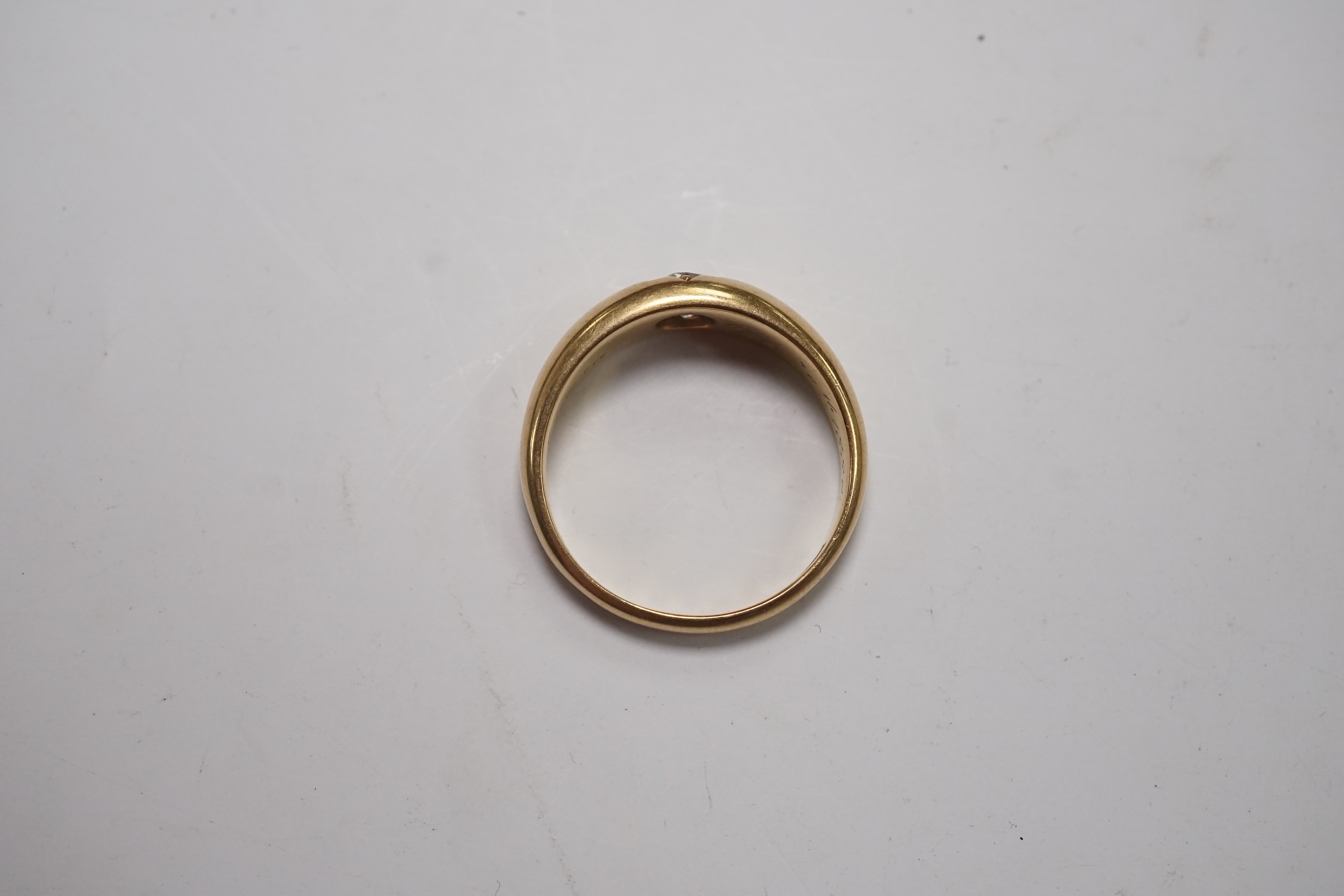 A late Victorian 18ct gold and gypsy set solitaire diamond ring, size Q/R, gross weight 7.7 grams. Condition - fair to good